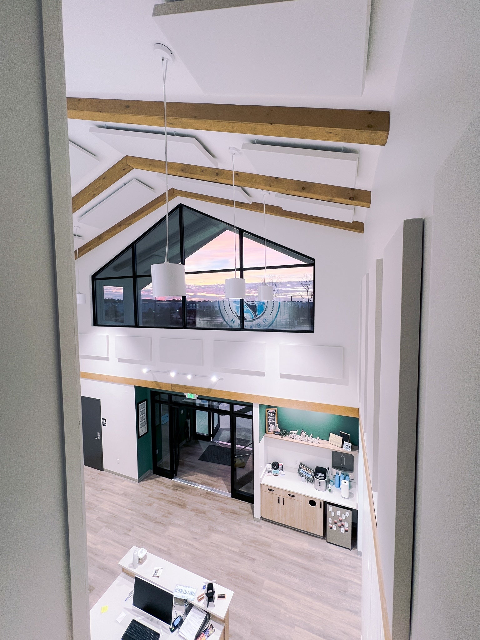 Modern office interior with a large TV screen on the wall.